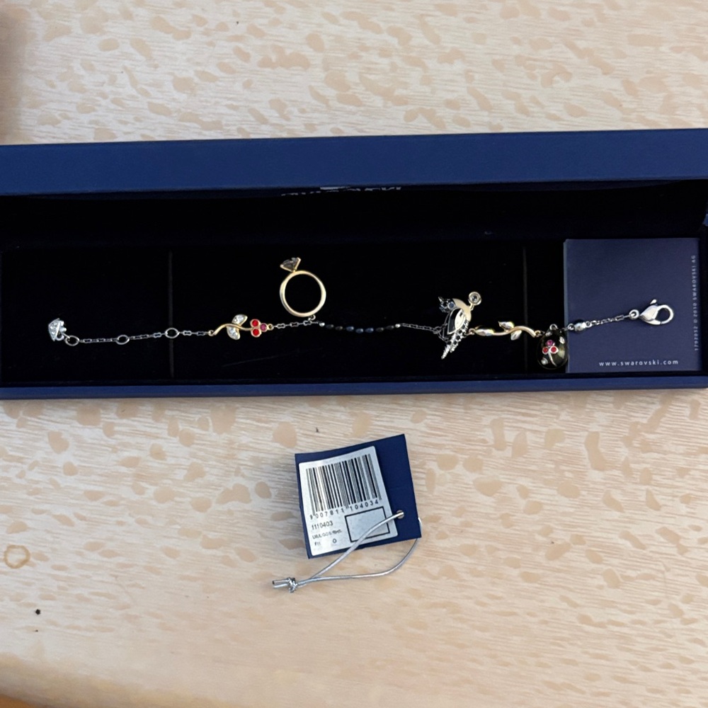 Swarovski Gold-Tone Bird Bracelet with Black Chain and Red Crystal Accents